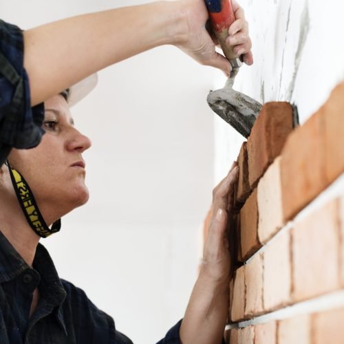 Constructor construction repair plastering on the wall